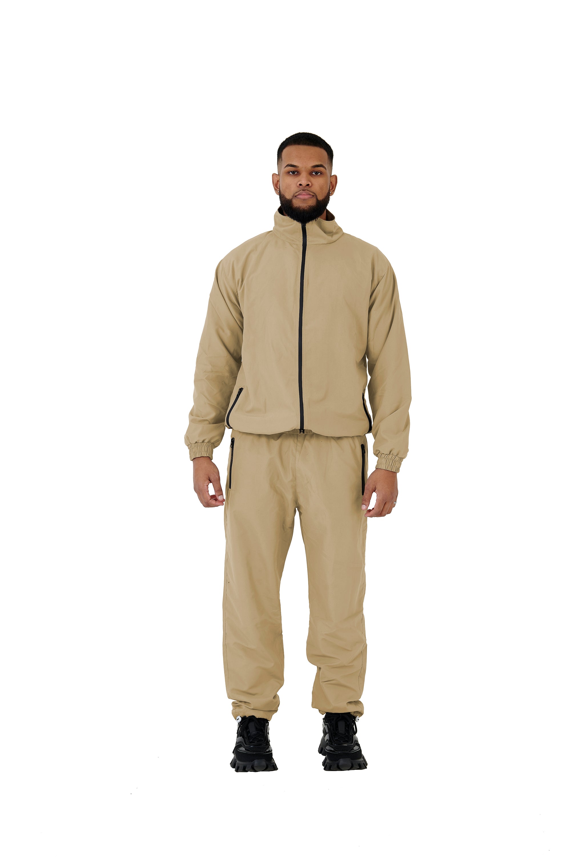 A wholesale supply of oversized nylon jackets with matching oversized nylon joggers is available.