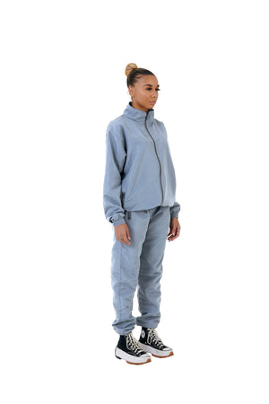 A wholesale supply of oversized nylon jackets with matching oversized nylon joggers is available.