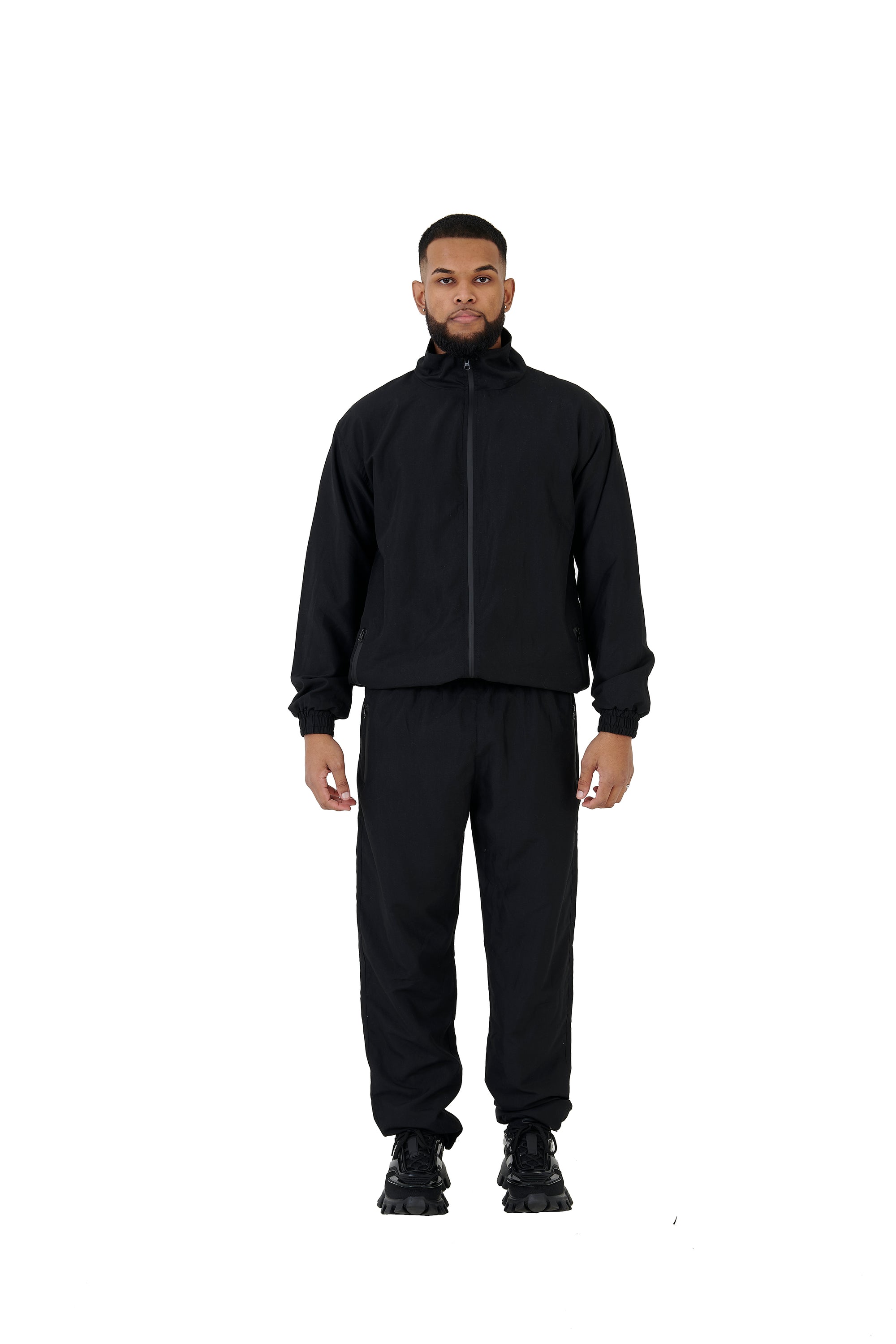 A wholesale supply of oversized nylon jackets with matching oversized nylon joggers is available.