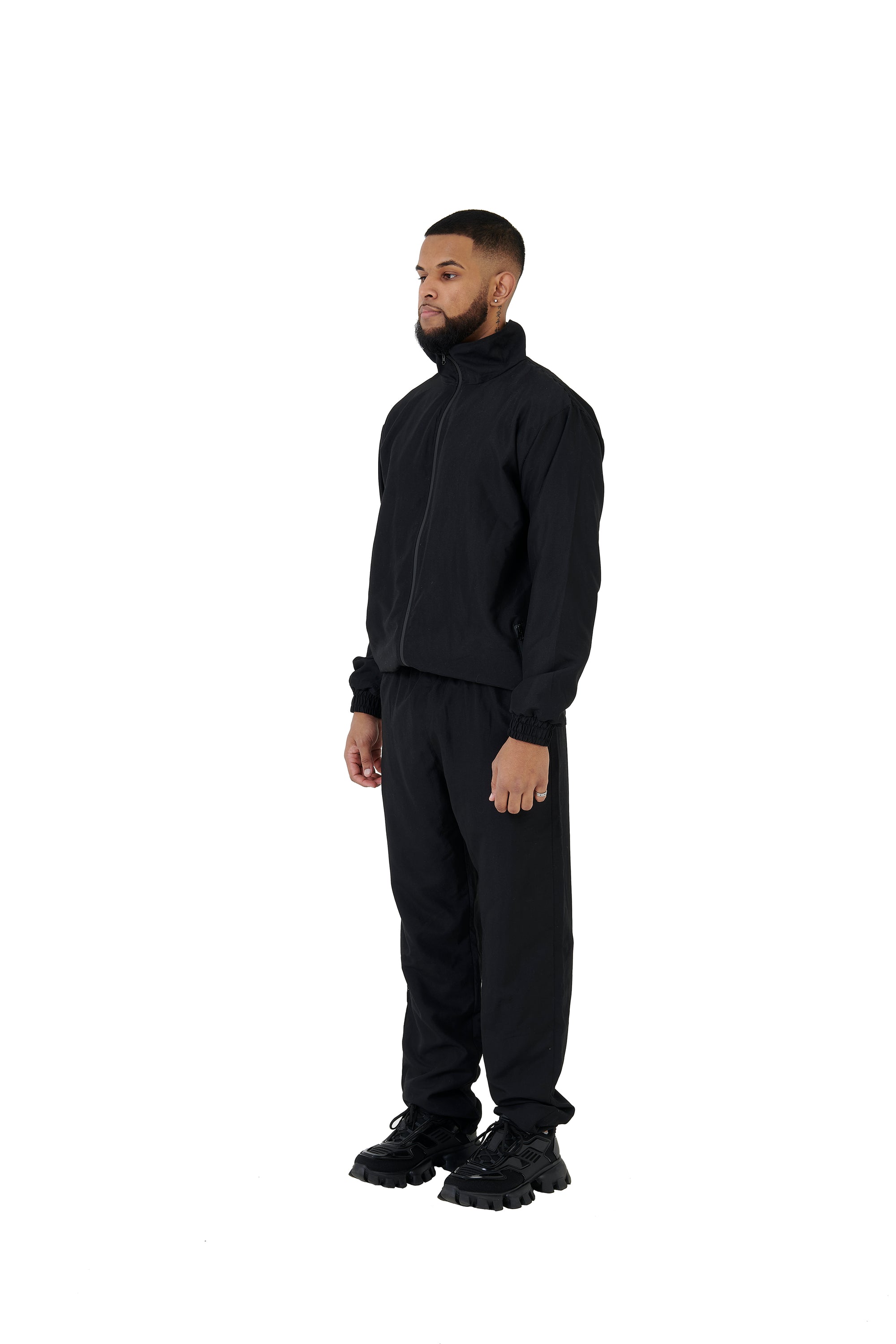 A wholesale supply of oversized nylon jackets with matching oversized nylon joggers is available.