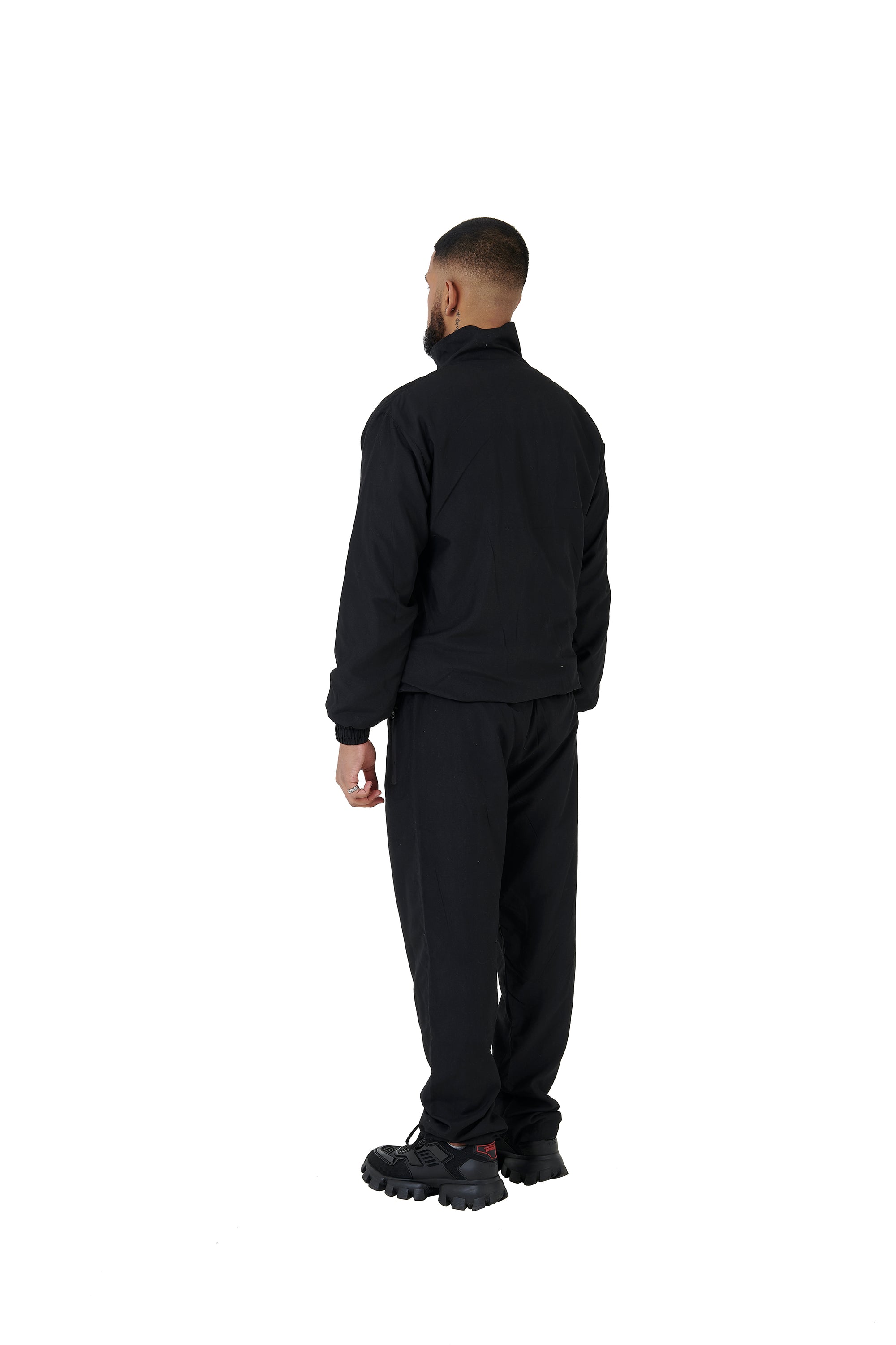 A wholesale supply of oversized nylon jackets with matching oversized nylon joggers is available.