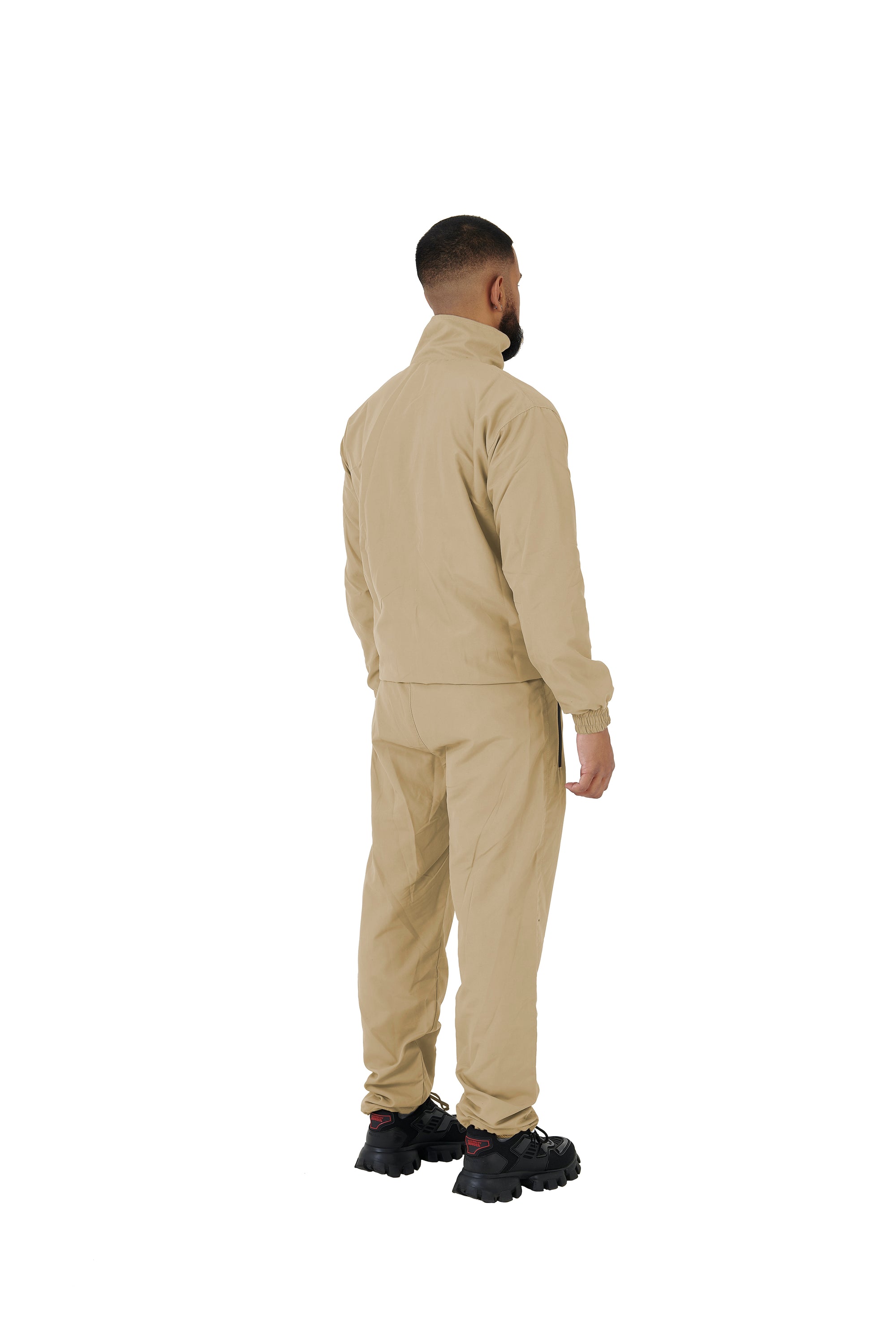 A wholesale supply of oversized nylon jackets with matching oversized nylon joggers is available.