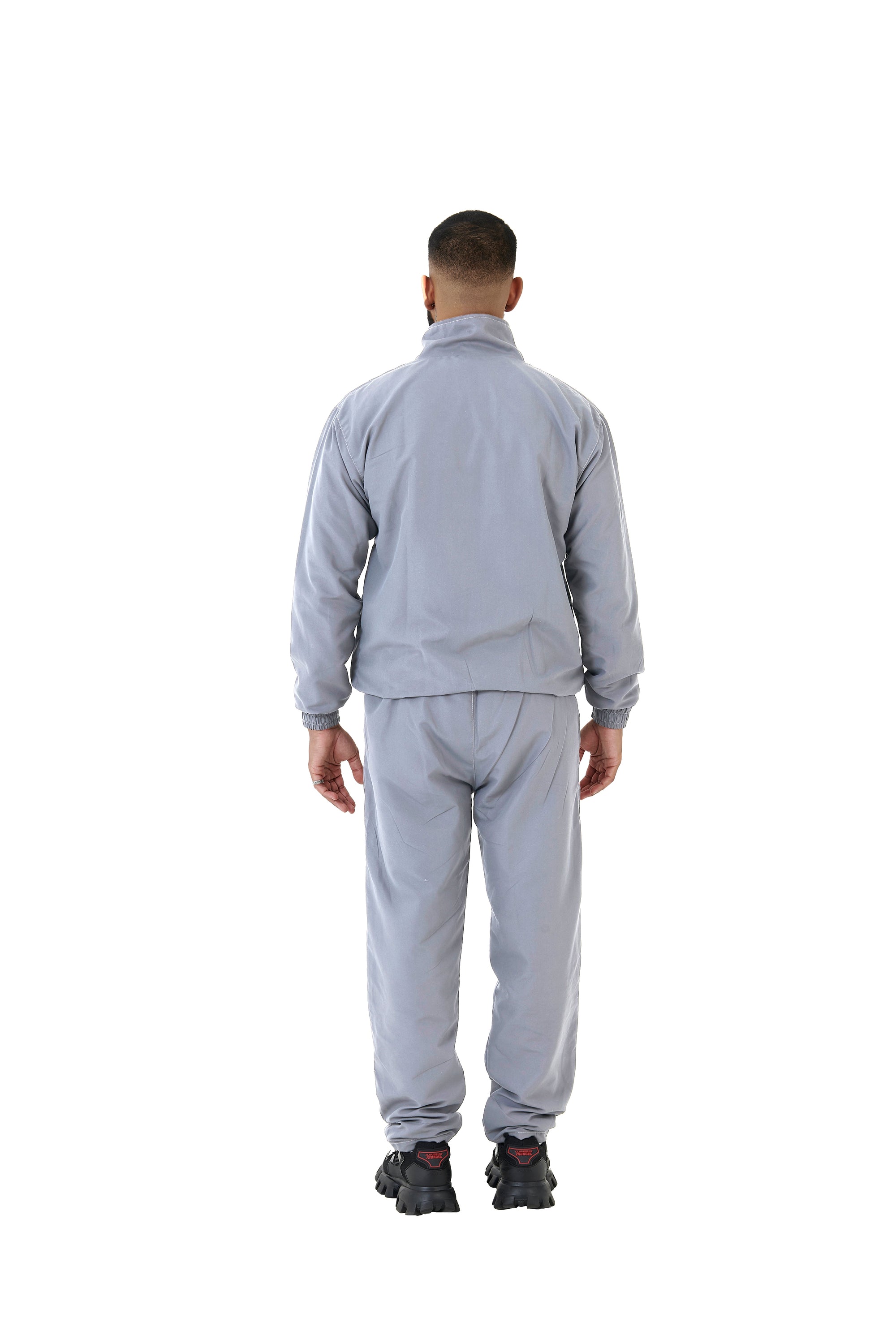 A wholesale supply of oversized nylon jackets with matching oversized nylon joggers is available.