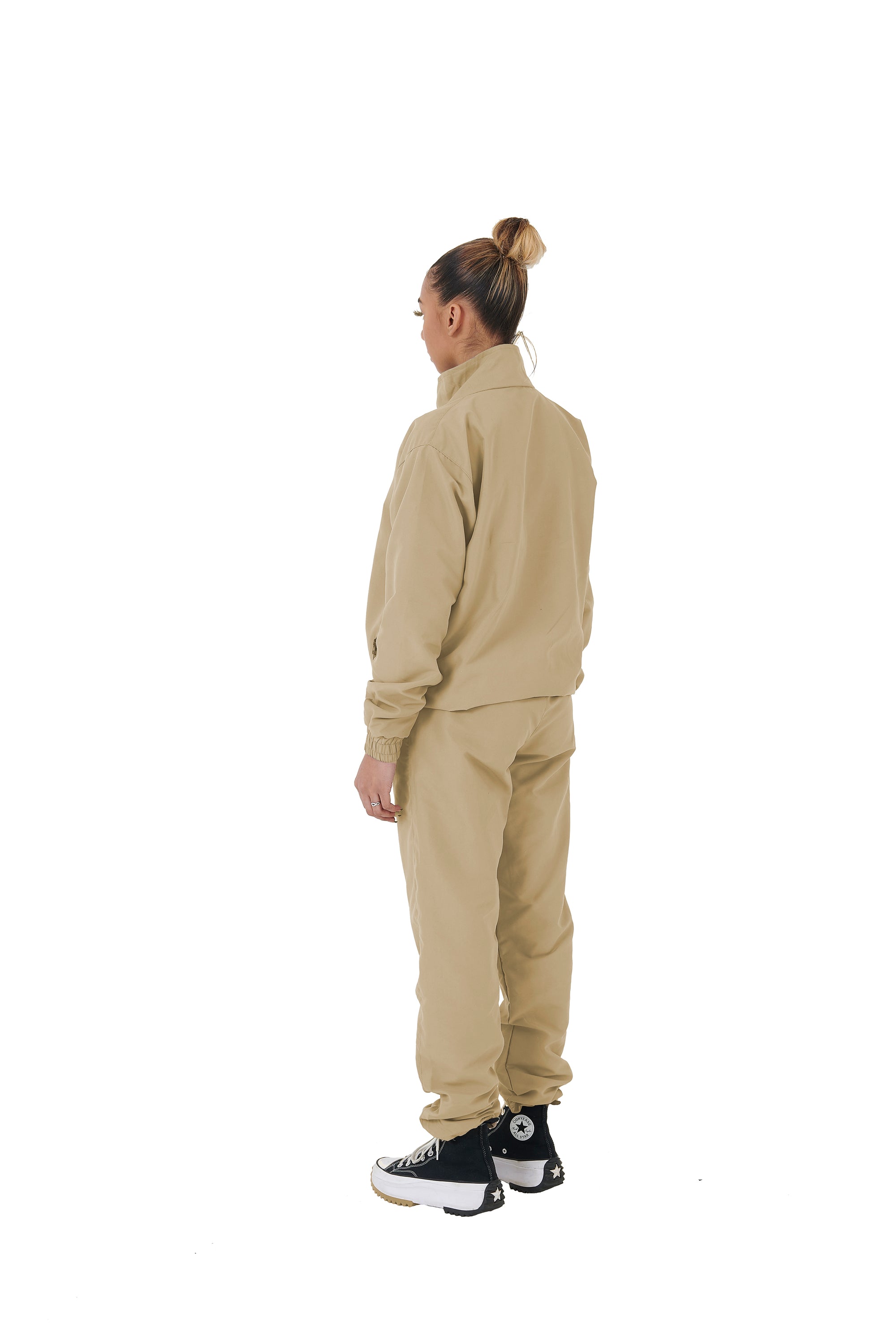 A wholesale supply of oversized nylon jackets with matching oversized nylon joggers is available.