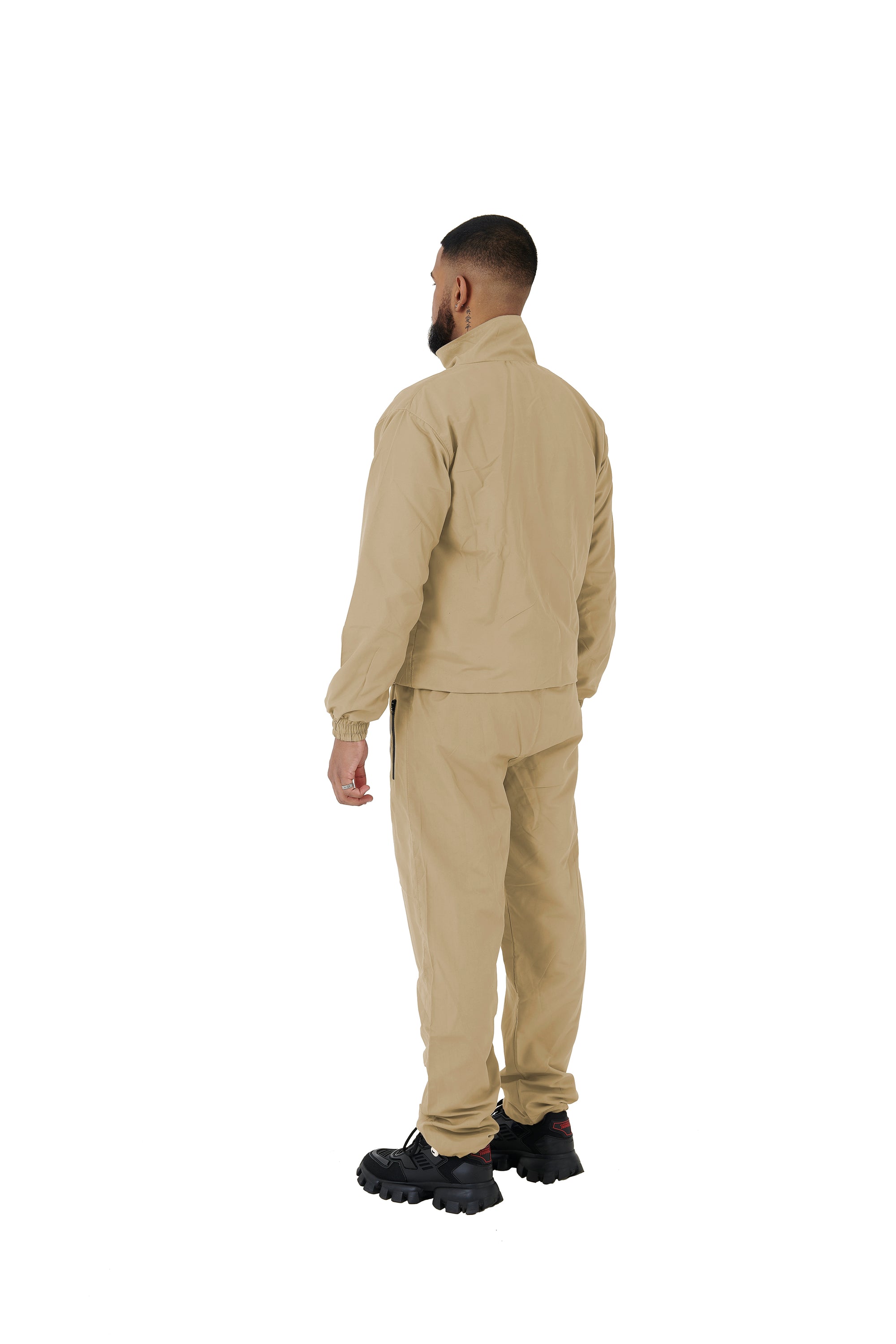 A wholesale supply of oversized nylon jackets with matching oversized nylon joggers is available.