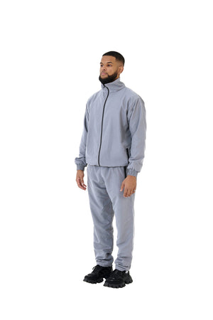 A wholesale supply of oversized nylon jackets with matching oversized nylon joggers is available.
