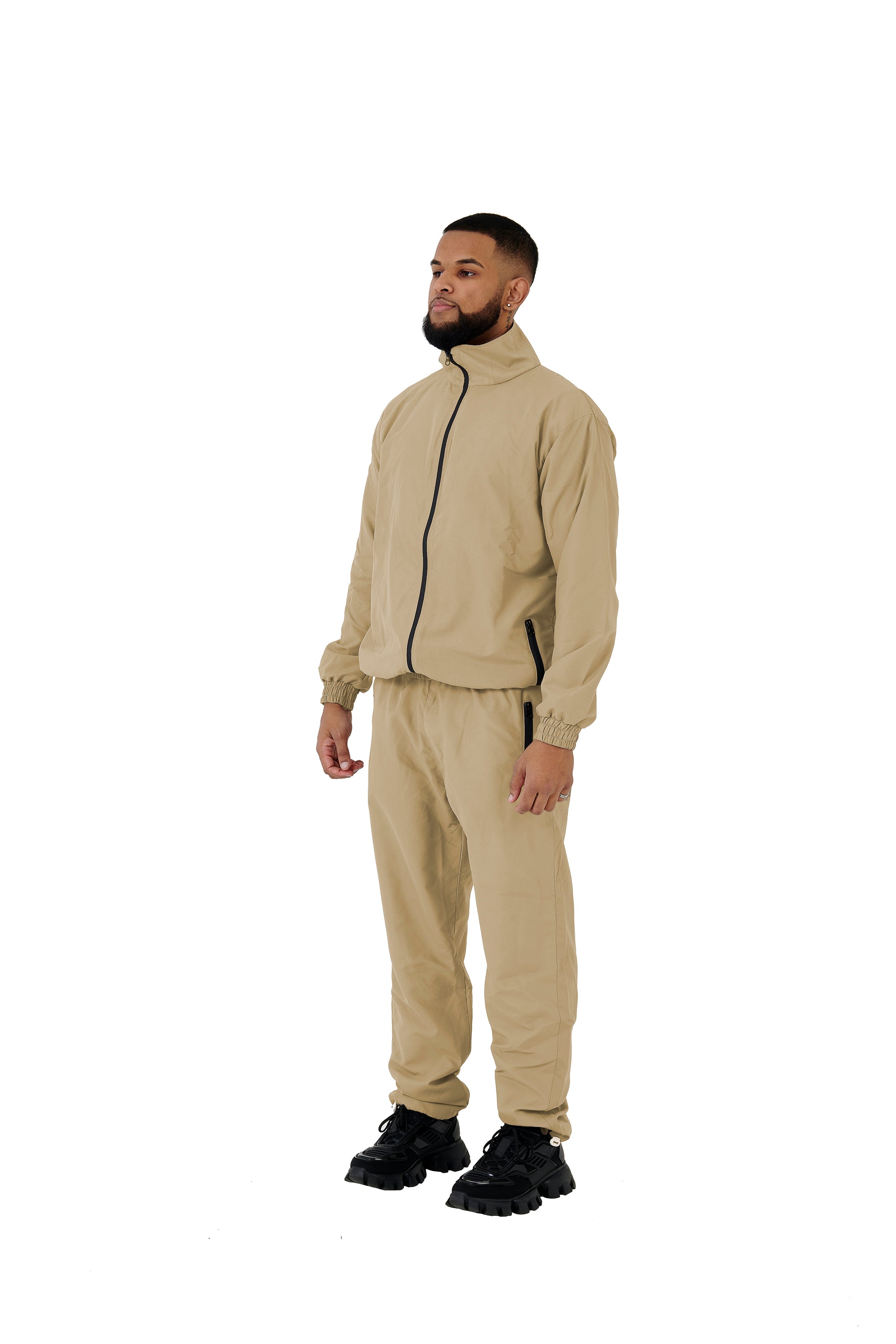 A wholesale supply of oversized nylon jackets with matching oversized nylon joggers is available.