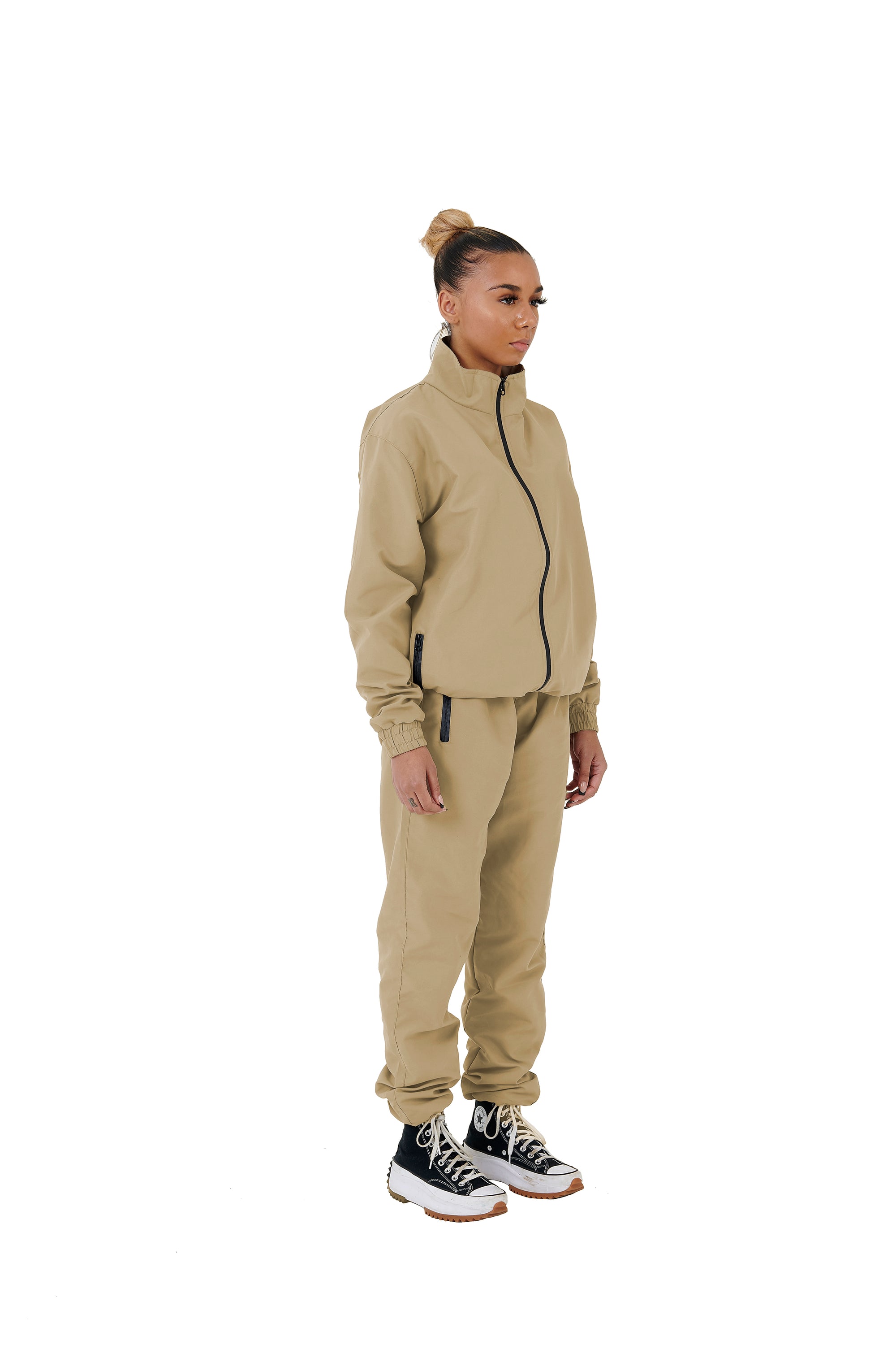 A wholesale supply of oversized nylon jackets with matching oversized nylon joggers is available.