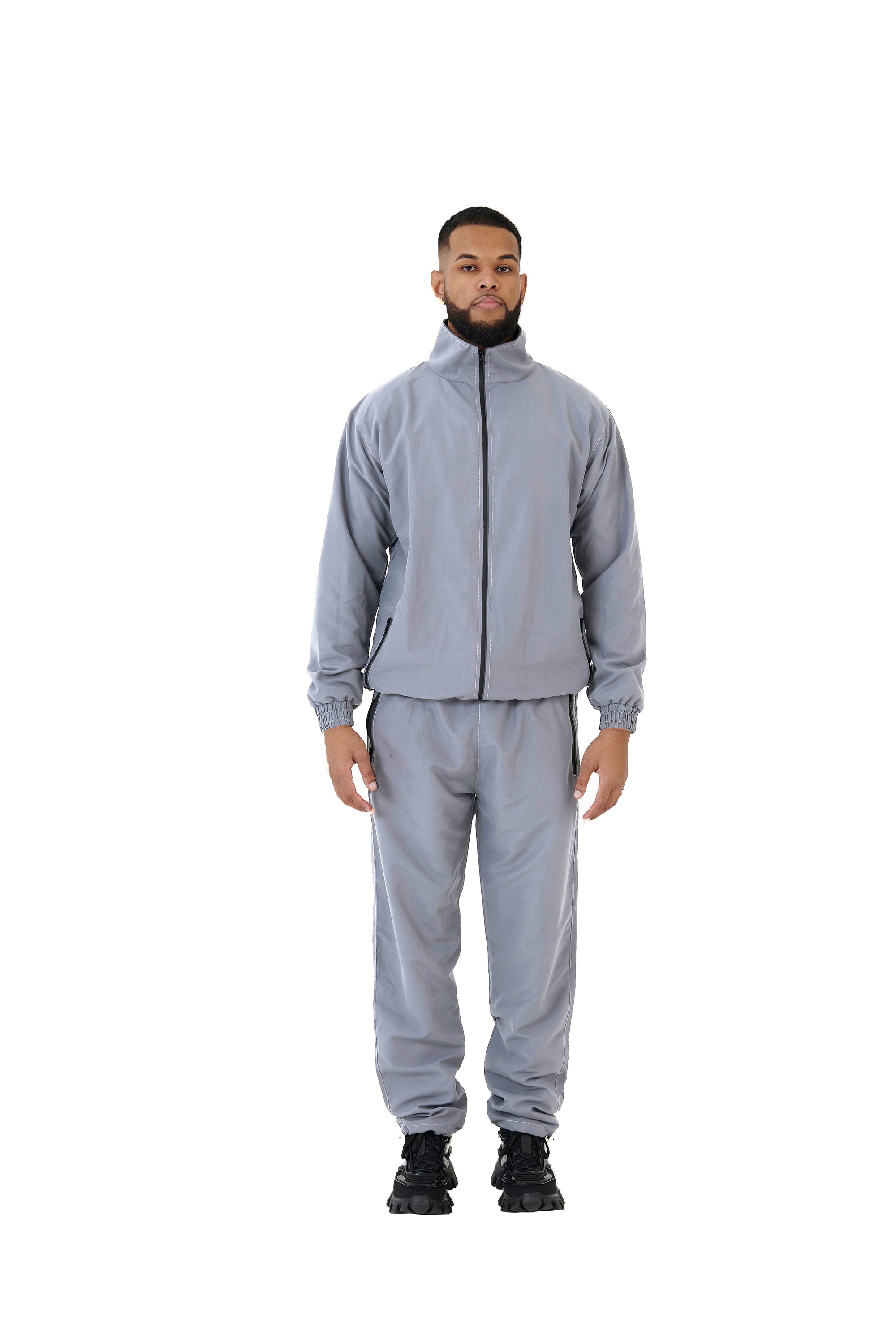 A wholesale supply of oversized nylon jackets with matching oversized nylon joggers is available.